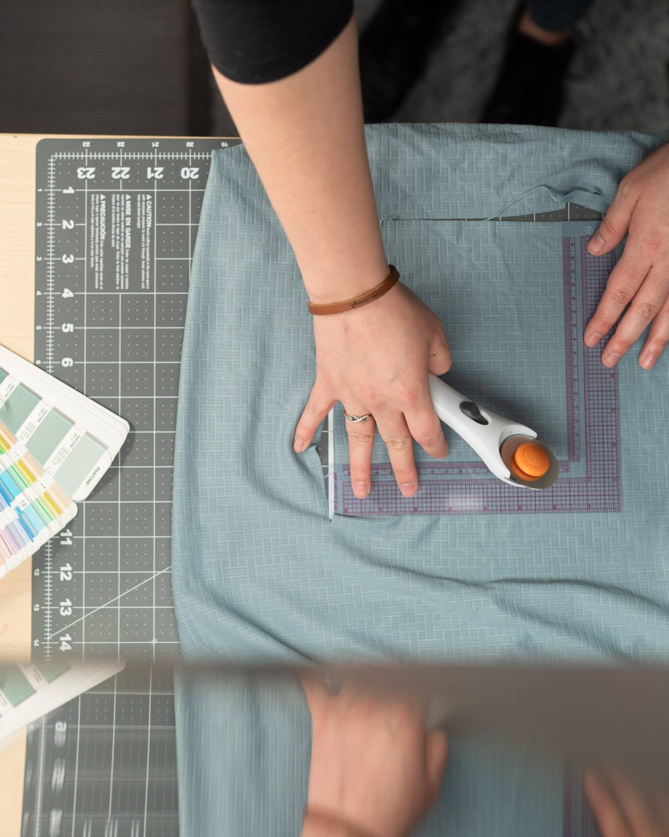 Threads team member cutting fabric sample