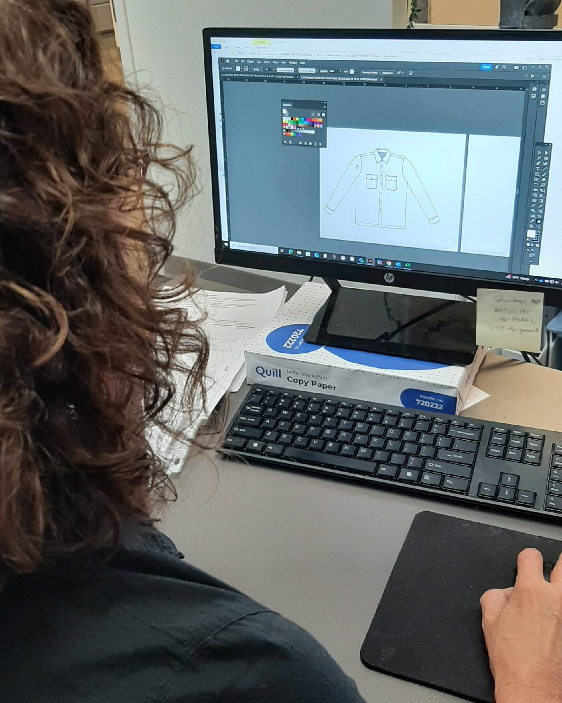 Naomi working on mockups of shirt on computer