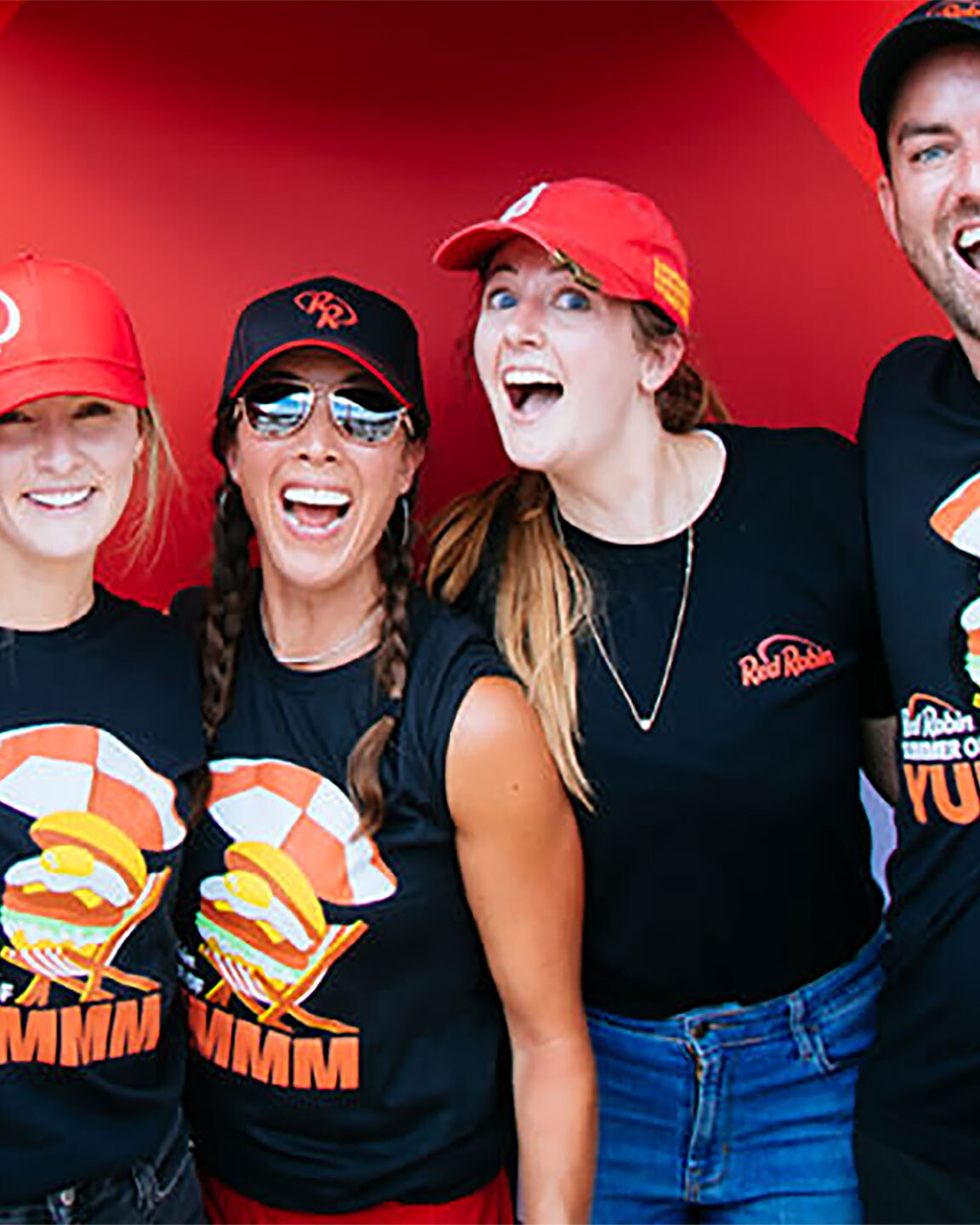 Group of Employees showing off Red Robin Summer Tee