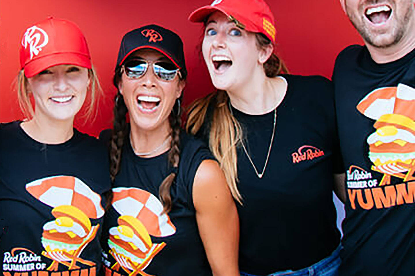 Group of Employees showing off Red Robin Summer Tee