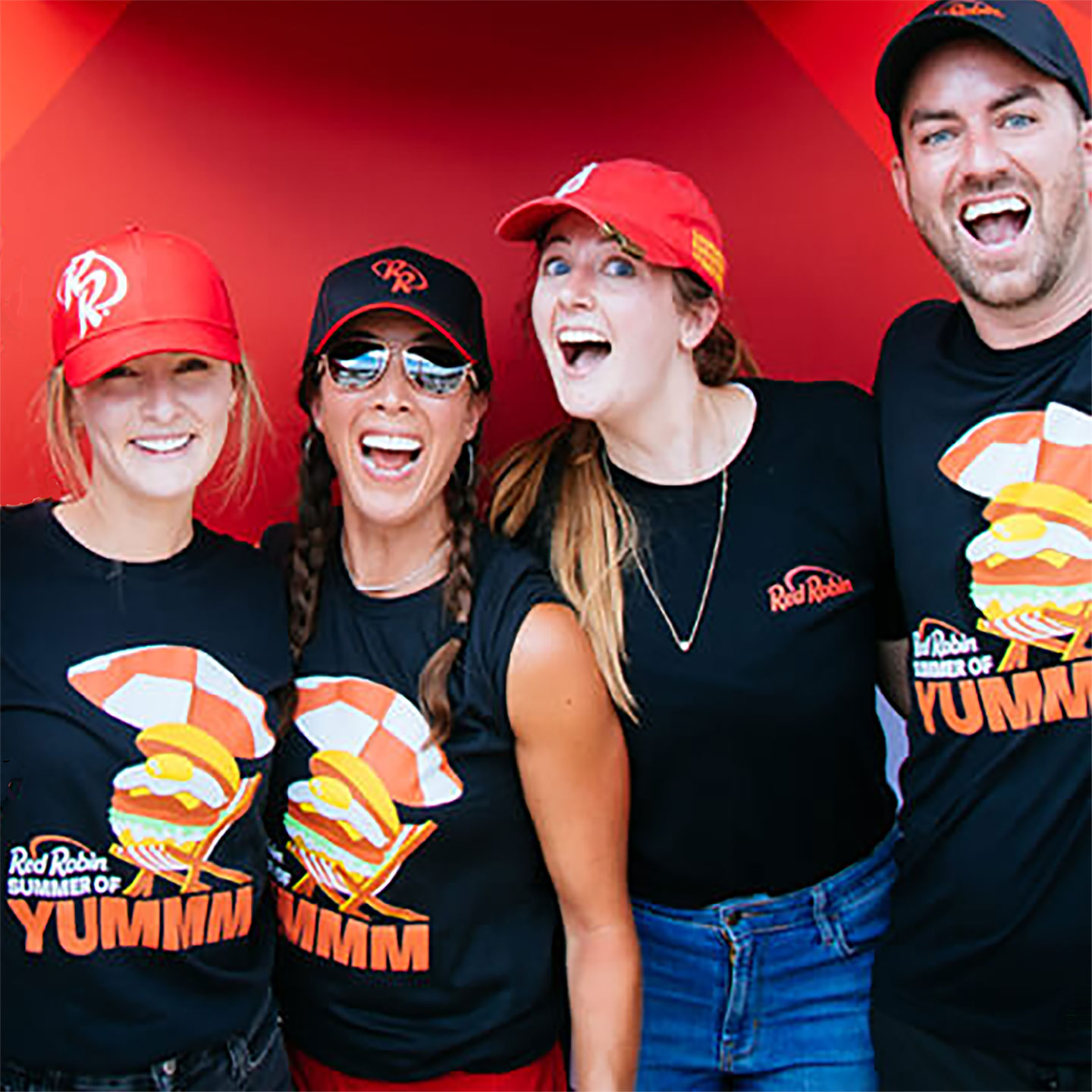 Group of Employees showing off Red Robin Summer Tee